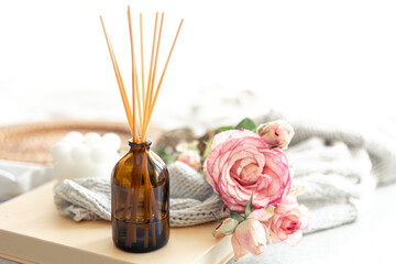 Spa composition with incense sticks and pink flowers.