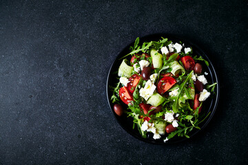 Mediterranean-style salad of cherry tomato, cucumber, arugula, feta cheese and smoked Kalamata olives