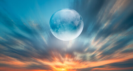 Crystal full moon over the clouds at sunset 