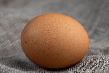 A whole orange chicken egg close-up on the table