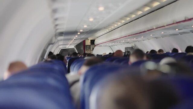 Cinematic view of interior of a plane with passengers on their seats