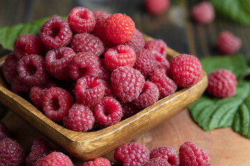 Ripe raspberries on a wooden board