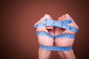 Diet and healthy lifestyle. The tape is wrapped around the arms.