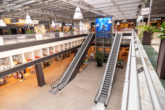 Turin, Italy - May 22, 2023: indoor pavilion with escalator at Lingotto Torino shopping center in the renovated former Fiat car factory