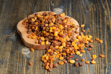 Dried yellow golden raisins on a board