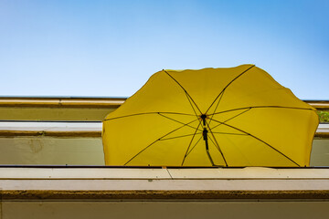 a yellow parasol on a balcony