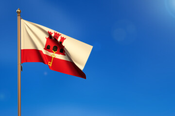 Gibraltar. Flag blown by the wind with blue sky in the background.