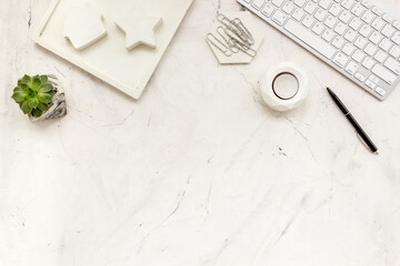 Workspace with diary, computer keyboard and succulent, top view