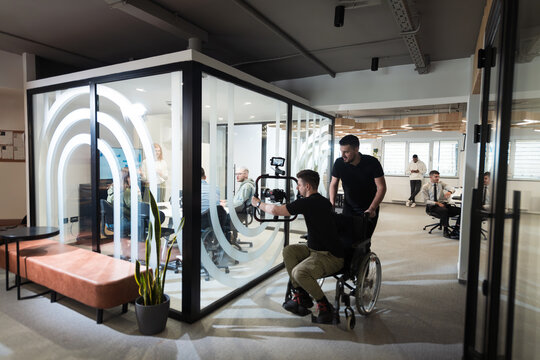 In a modern office, a professional team of videographers captures the essence of creativity and innovation as they film a group of young entrepreneurs, symbolizing collaboration and ambition in the