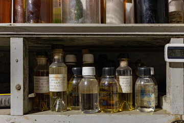 In a cognac cellar and distillery, there are petite flacons containing chemicals and samples neatly...