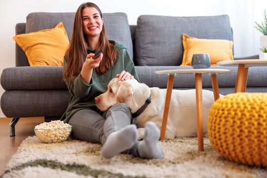 Woman and dog watching TV