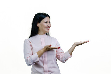 Smiling young cheerful asian woman showing copy space with both hands. Isolated on white background.