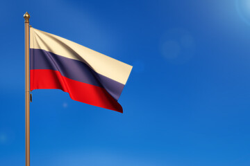 Russia. Flag blown by the wind with blue sky in the background.