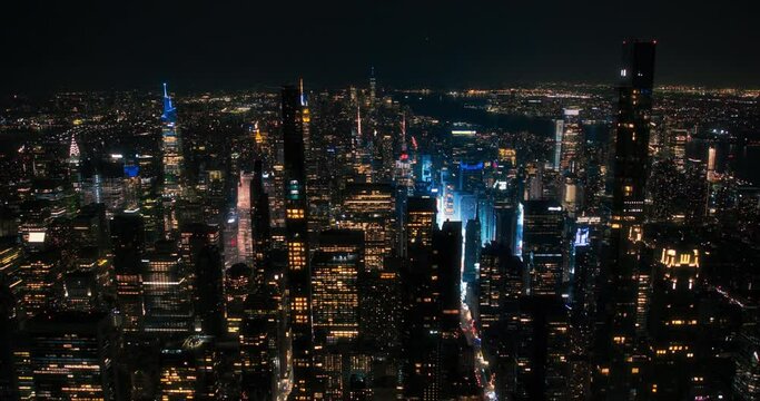 New York City Aerial Skyline with Historic and Modern Manhattan Skyscrapers and Residential Buildings at Night. Scenic Helicopter View of Popular Tourist and Business Attractions in the Dark