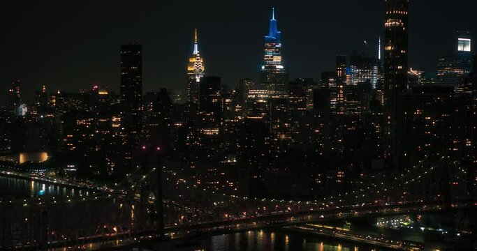 Aerial Helicopter Footage Over Ed Koch Queensboro Bridge with Manhattan Skyscrapers Cityscape. Beautiful Late Evening Footage Focusing on Upper East Side Office Buildings at Night