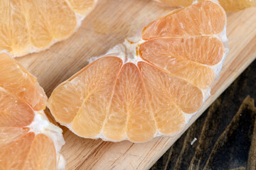 Freshly peeled pink pomelo on the table