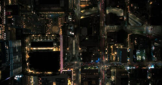 Cinematic Helicopter Night Footage Moving Diagonally Over New York City Avenue Grid System. Top Down Aerial Footage of Congested Streets, Roads, Cars, Nightlife and Tall Modern Skyscrapers
