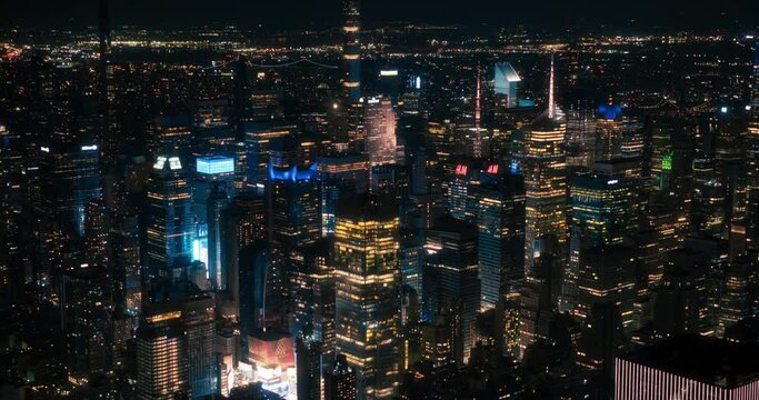 Helicopter Tour of New York Cityscape at Night. Fly-By Over Manhattan with Panorama of Office Buildings with Lights and Congested Streets with Cars and Taxi Vehicles in a Big City