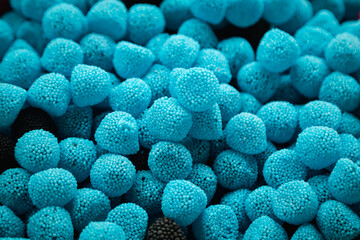 Background of blueberry soft gummy candy, blue raspberries, delicious treats close up.