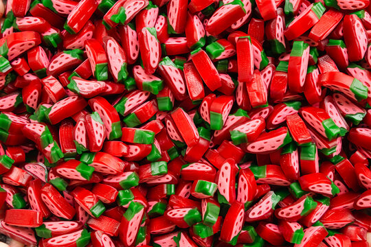 Candy background of chewy sweets in the form of strawberries, top view.