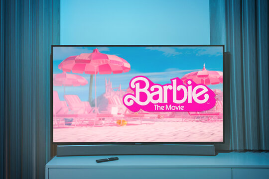 The barbie movie logo and poster on TV screen