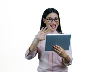 Fototapeta premium Young asian businesswoman is holding a tablet computer and waving her hand. Saying hi to someone online via video conversation. Isolated on white background.