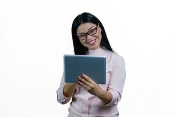 Fototapeta premium Young smiling asian businesswoman having online conversation via tablet pc. Cheerful korrean nerdy girl with modern device. Isolated on white background.