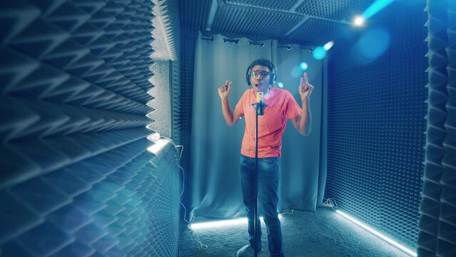 African-american performer is singing in the soundproof music studio