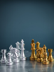 Set of golden and silver chess pieces element, king, queen rook, bishop, knight, pawn standing on hexagon pattern chessboard on blue background. Competition, game, war, emulation and planning concept. © tete_escape