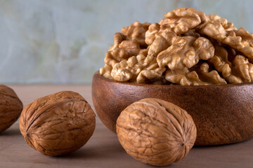 A bowl of peeled walnuts and a group of shelled walnuts
