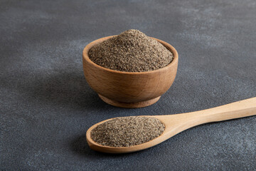 Powder black pepper on black  background,top view