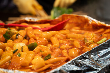 Delicious Korean cuisine Tteokbokki, spicy rice cake in market, street food.
