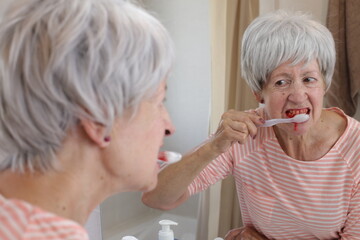 Brutal senior woman with bleeding gums 