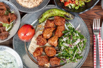 Turkish cuisine Meat Shish. Shish kebab prepared on a barbecue grill on hot coals with grilled...
