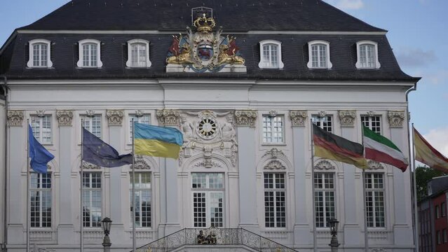 Flags wave in front of old town hall in Bonn, Germany. It was built in rococo style 1737 - 1738 by the architect of the imperial court Michael Leveilly.
