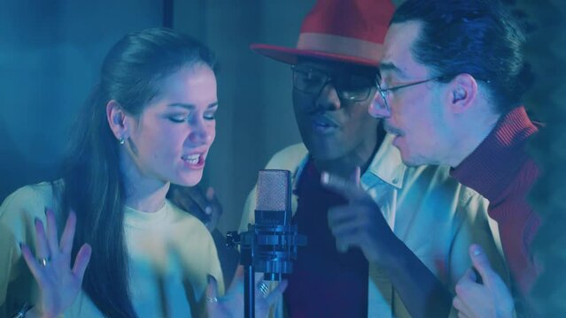 Recording booth with a group of performers singing