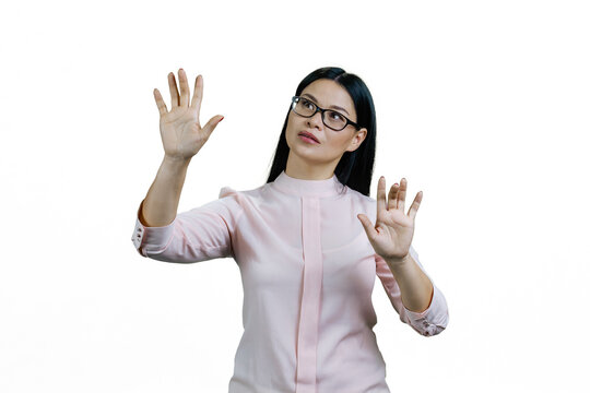 Young smart asian woman is touching invisible virtual screen with both hands. Amazed korean businesswoman is interacting with copy space. Isolated on white. - Powered by Adobe