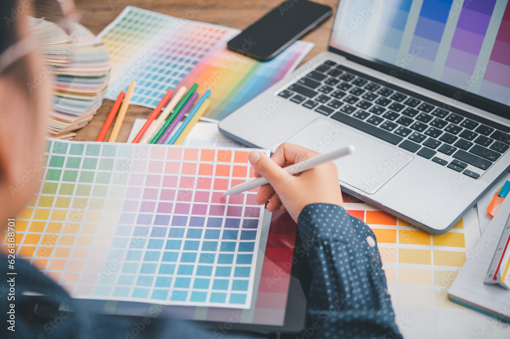 Fototapete Graphic designer architects who work with laptops and color comparison tables for design work..