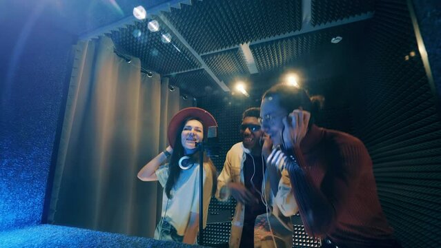 Music band is getting recorded in the studio. Sound production concept.