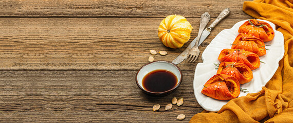 Baked Hokkaido pumpkin with sauce, spices and honey. Healthy vegan food, dry rosemary