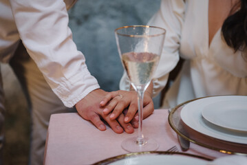 Couple hands. Engagement ring. Propose of hand and heart. Man making a marriage proposal to female. Luxury romantic date. Table setting in restaurant. Dinner setup table for couple on Valentines day.
