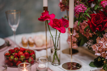 Table setting in restaurant. Location for surprise marriage proposal. Engagement. Decoration flowers, decor candles. Luxury romantic date. Candle light dinner setup table for couple on Valentines day.