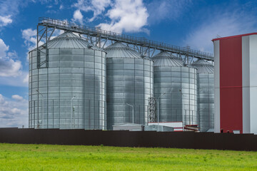 agro silos on agro-industrial complex and grain drying and seeds cleaning line. © hiv360