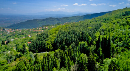Panoramic shot on the city in the mountains in early spring. Top view from a drone