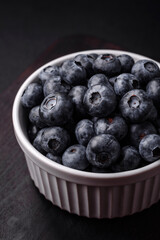 Delicious fresh sweet blueberries in a ceramic bowl. Vegan food