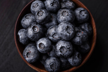 Delicious fresh sweet blueberries in a ceramic bowl. Vegan food