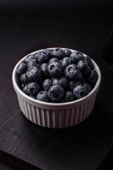 Delicious fresh sweet blueberries in a ceramic bowl. Vegan food