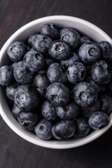 Delicious fresh sweet blueberries in a ceramic bowl. Vegan food