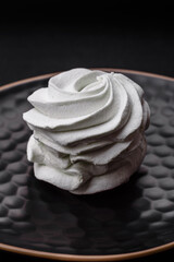 Delicious sweet colored marshmallow on a dark concrete background