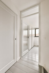 an empty room with white walls and wood flooring the door is open to let in light into the room
